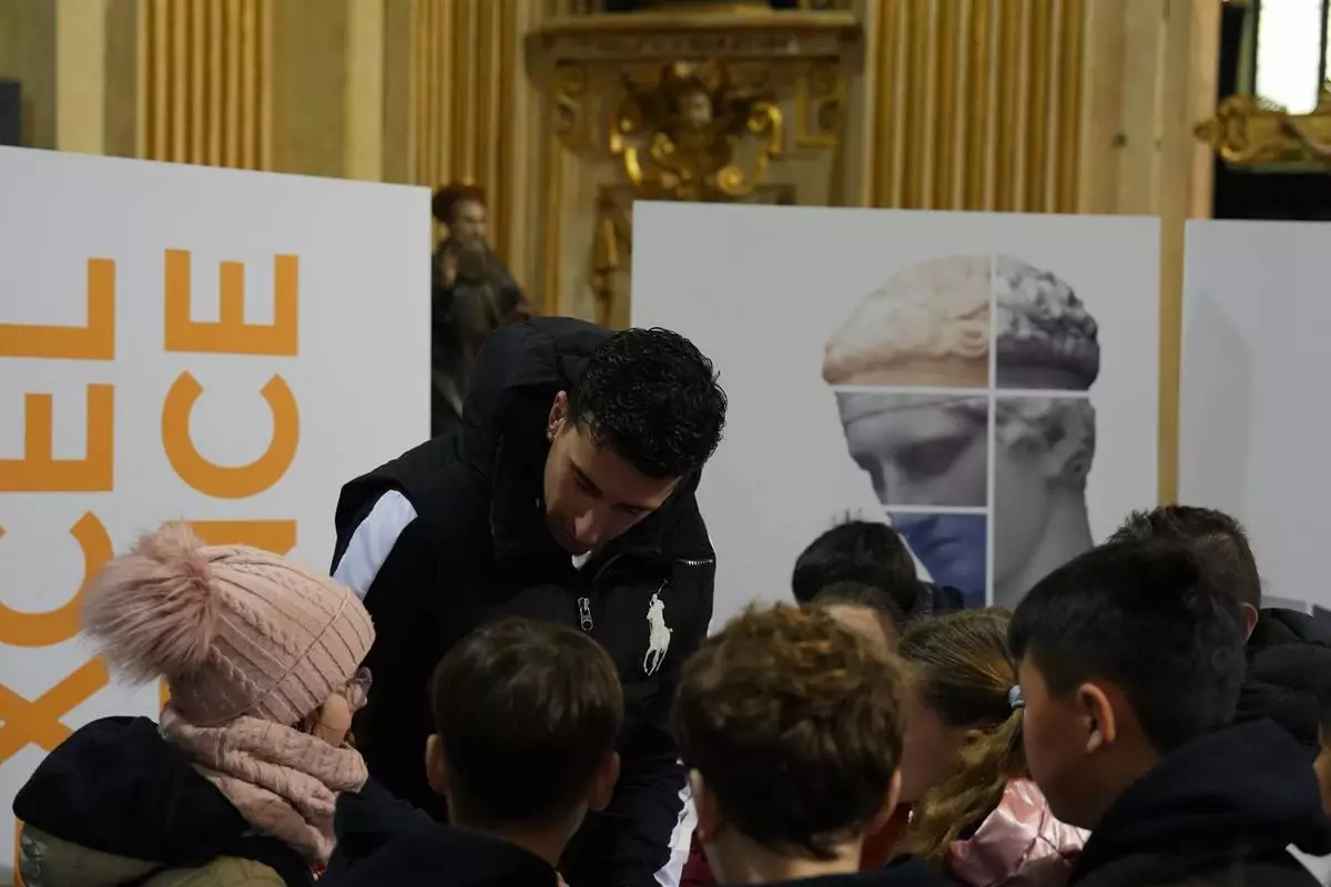 Basketball player Giordano Bertolani speaks to children during a values-focused activity at the Church of Sant’Antonio, part of a church-led initiative tied to the 2026 Winter Olympics, in Milan, Italy, Monday, Feb. 9, 2026. (AP Photo/María Teresa Hernandez)