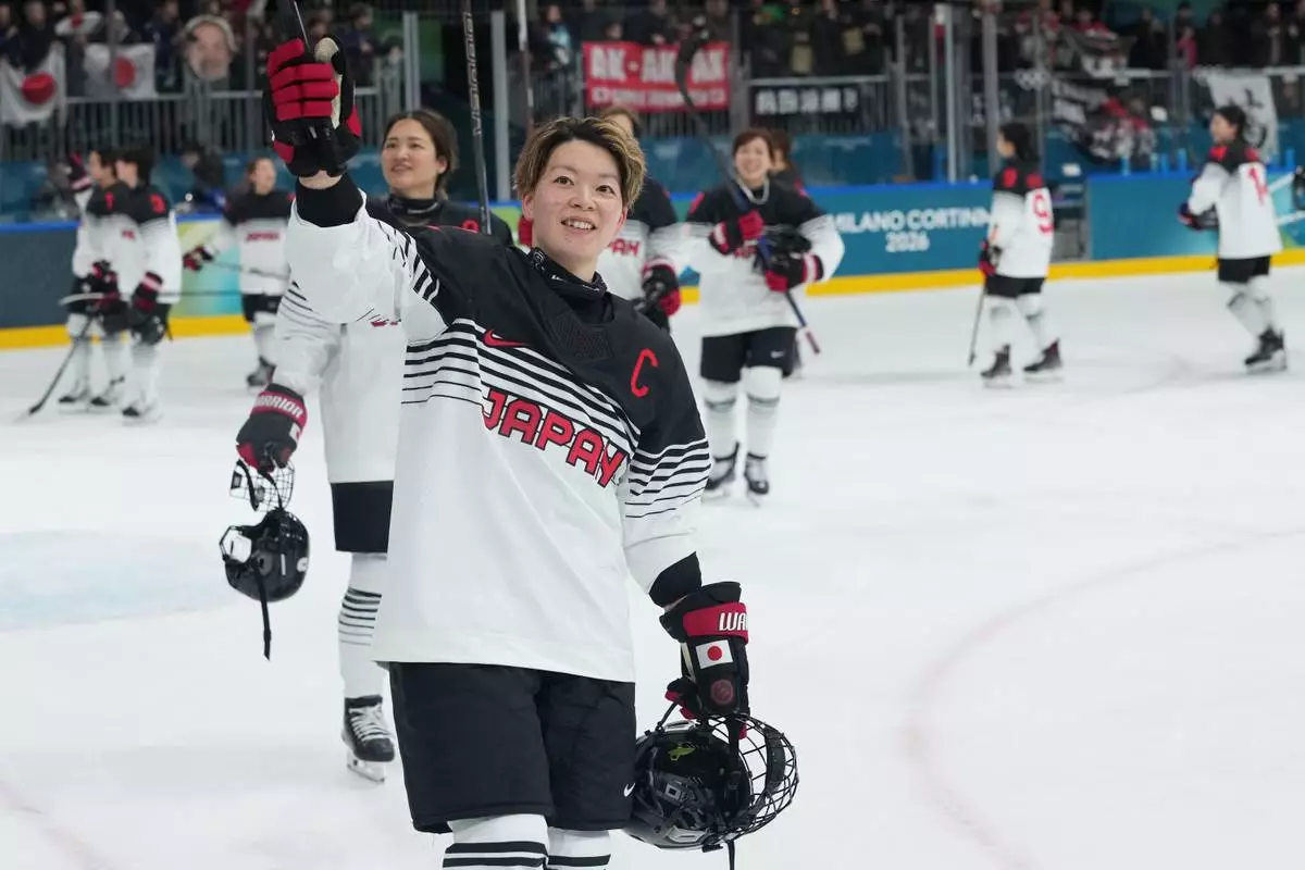 Japan's Shiori Koike and her teammates celebrate after a preliminary round match of women's ice hockey between France and Japan at the 2026 Winter Olympics, in Milan, Italy, Friday, Feb. 6, 2026. (AP Photo/Carolyn Kaster)