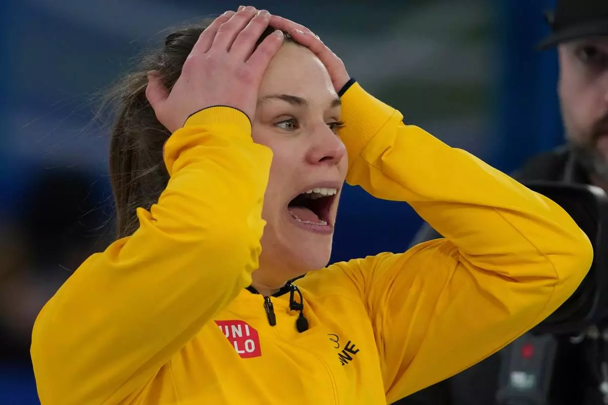 Sweden's Anna Hasselborg reacts during a women's curling semifinal match against Canada, at the 2026 Winter Olympics, in Cortina d'Ampezzo, Italy, Friday, Feb. 20, 2026. (AP Photo/Misper Apawu)