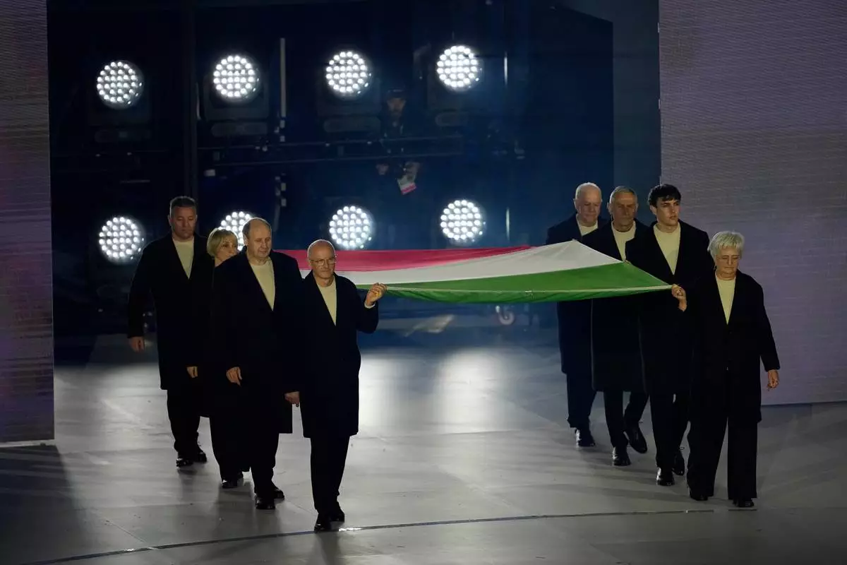 Flagbearers carry the Italian flag during the closing ceremony of the 2026 Winter Olympics, in Verona, Italy, Sunday, Feb. 22, 2026. (AP Photo/Ashley Landis)