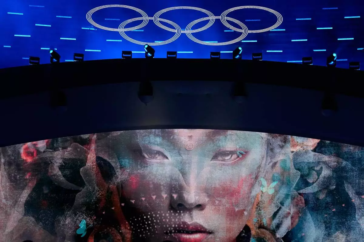The Olympic rings are illuminated during a performance at the closing ceremony of the 2026 Winter Olympics, in Verona, Italy, Sunday, Feb. 22, 2026. (AP Photo/Natacha Pisarenko)