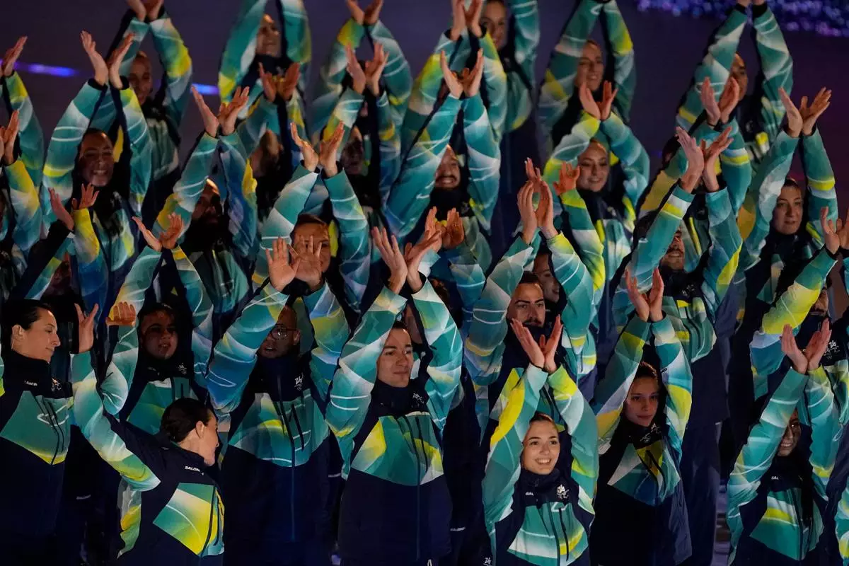 Olympic volunteers perform during the closing ceremony of the 2026 Winter Olympics, in Verona, Italy, Sunday, Feb. 22, 2026. (AP Photo/Ashley Landis)