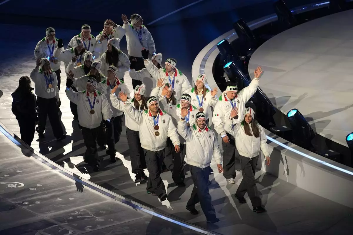 Italian medallists arrive for the closing ceremony of the 2026 Winter Olympics, in Verona, Italy, Sunday, Feb. 22, 2026. (AP Photo/Antonio Calanni)