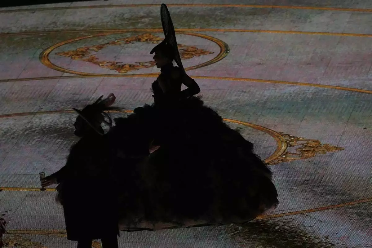 Artists are silhouetted as they perform during the closing ceremony of the 2026 Winter Olympics, in Verona, Italy, Sunday, Feb. 22, 2026. (AP Photo/Antonio Calanni)