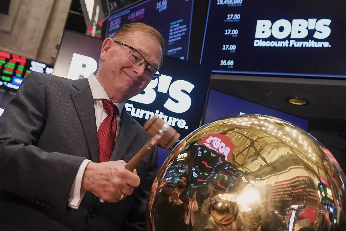 Bob's Discount Furniture President &amp; CEO Bill Barton rings a ceremonial bell on the floor of the New York Stock Exchange as his company's IPO begins trading, Thursday, Feb. 5, 2026. (AP Photo/Richard Drew)