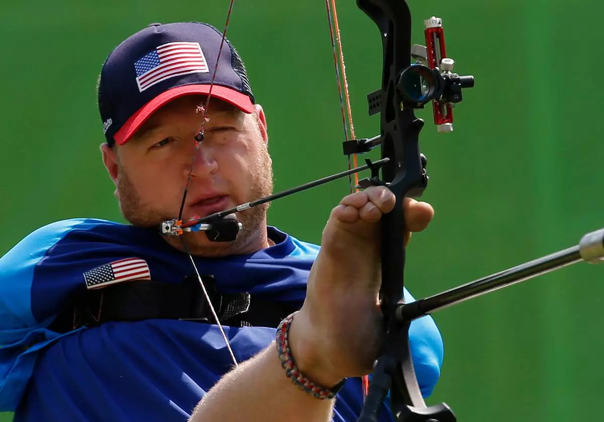 FILE - Matt Stutzman, of the United States, holds the bow with his foot as he competes in the individual compound-open, during the Paralympic Games at the Sambadrome, in Rio de Janeiro, Brazil, Sept. 14, 2016. (AP Photo/Silvia Izquierdo, File)