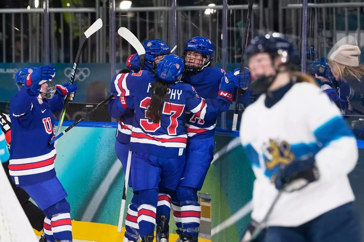 United States' Taylor Heise, 2nd right, celebrates with teammates after scoring her sides second goal during a preliminary round match of women's ice hockey between the United States and Finland at the 2026 Winter Olympics, in Milan, Italy, Saturday, Feb. 7, 2026. (AP Photo/Petr David Josek)