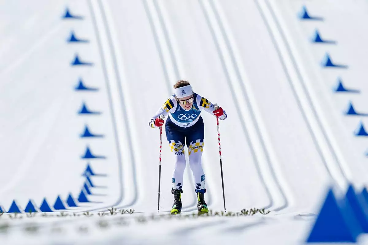 Ebba Andersson, of Sweden, approaches the finish line to win the gold medal in the cross country skiing women's 50km mass start classic at the 2026 Winter Olympics, in Tesero, Italy, Sunday, Feb. 22, 2026. (AP Photo/Matthias Schrader)