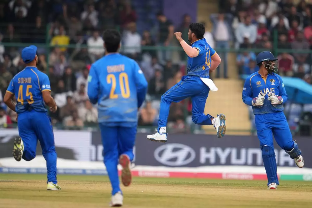 United Arab Emirates' Haider Ali, centre, celebrates the wicket of during the T20 World Cup cricket match between South Africa and United Arab Emirates in New Delhi, India, Wednesday, Feb. 18, 2026. (AP Photo/Manish Swarup)