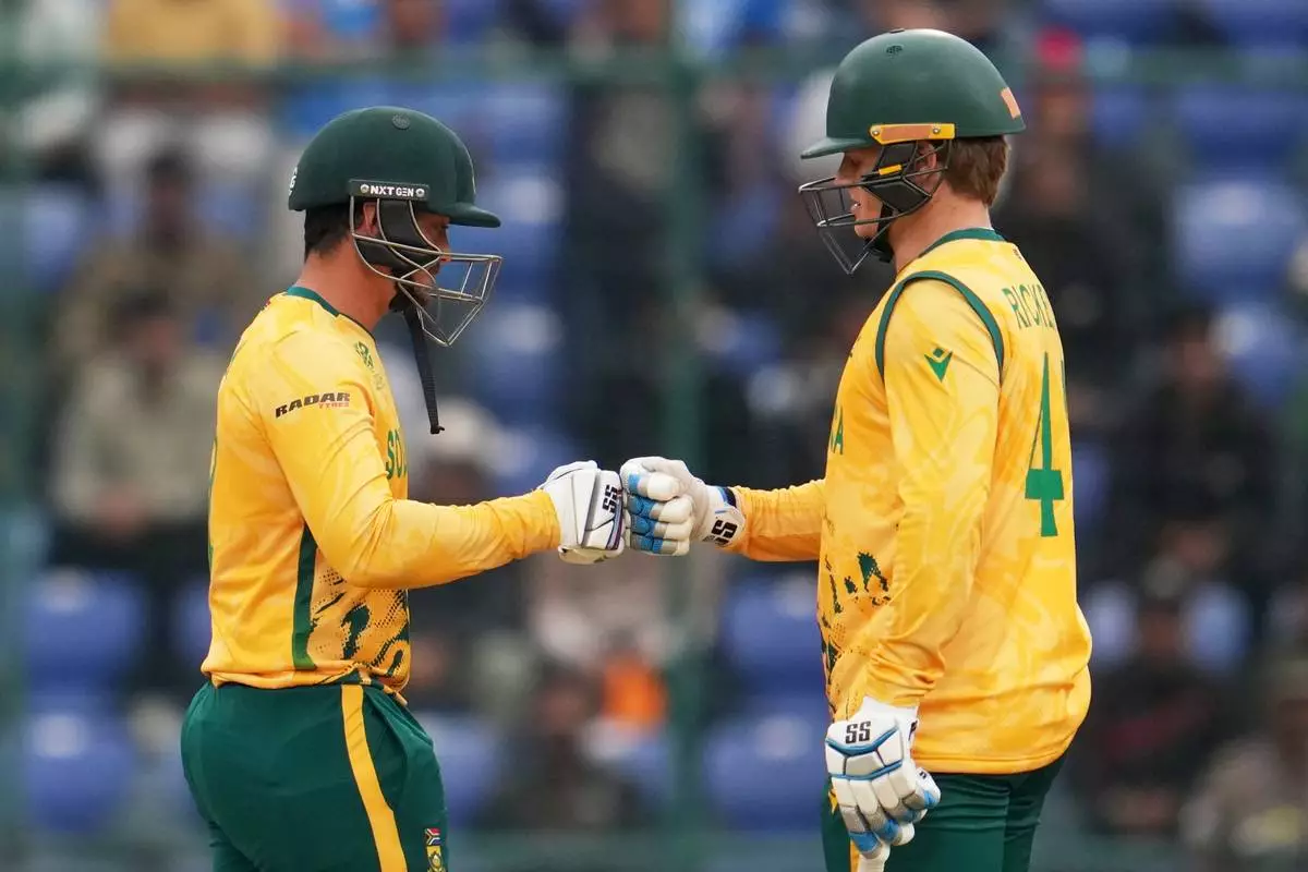 South Africa's Quinton de Kock and Ryan Rickelton celebrate during the T20 World Cup cricket match between South Africa and United Arab Emirates in New Delhi, India, Wednesday, Feb. 18, 2026. (AP Photo/Manish Swarup)