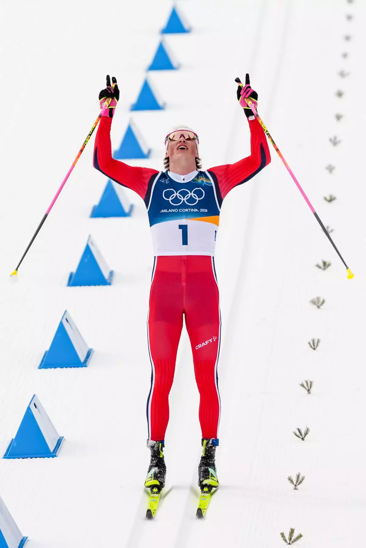 Johannes Hoesflot Klaebo, of Norway, crosses the finish line to win the gold medal during the cross country skiing men's 50km mass start Classic at the 2026 Winter Olympics, in Tesero, Italy, Saturday, Feb. 21, 2026. (AP Photo/Kirsty Wigglesworth)