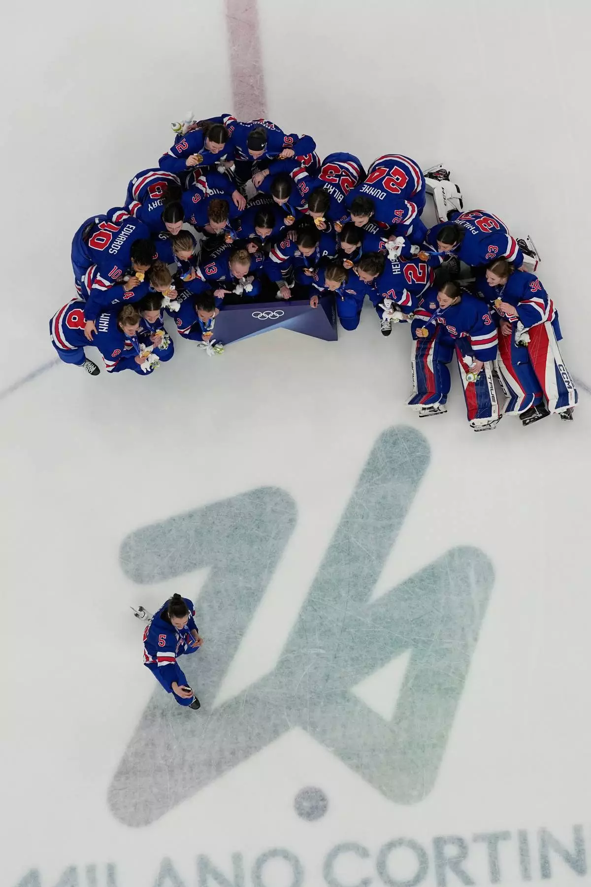 United States' Megan Keller (5) takes a photographer with the team after the United States beat Canada 2-1 in overtime in the women's ice hockey gold medal game at the 2026 Winter Olympics, in Milan, Italy, Thursday, Feb. 19, 2026. (AP Photo/David J. Phillip)
