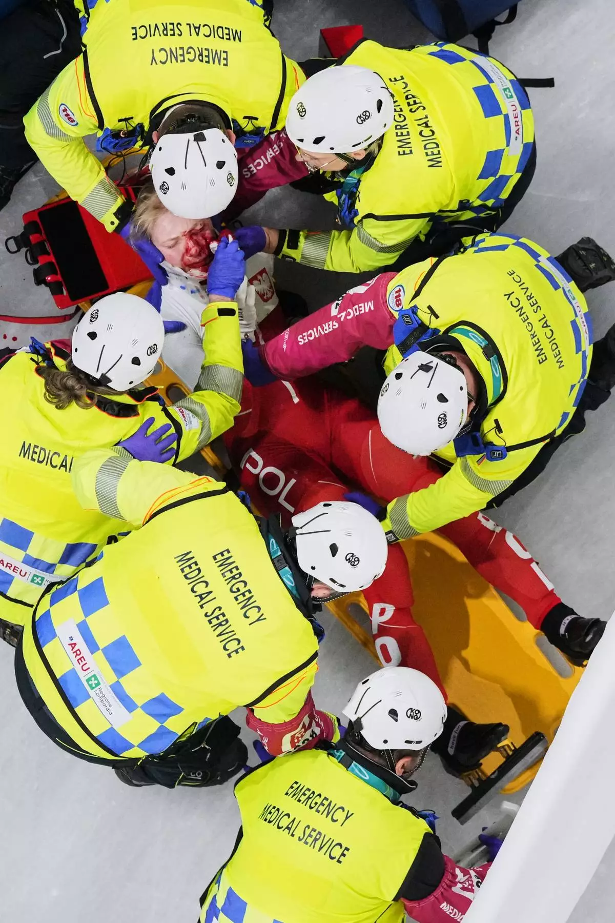 Kamila Sellier of Poland is assisted by the emergency medical service team after an injury due to a fall during a short track speed skating women's 1500 meters quarterfinal at the 2026 Winter Olympics, in Milan, Italy, Friday, Feb. 20, 2026. (AP Photo/Bernat Armangue)