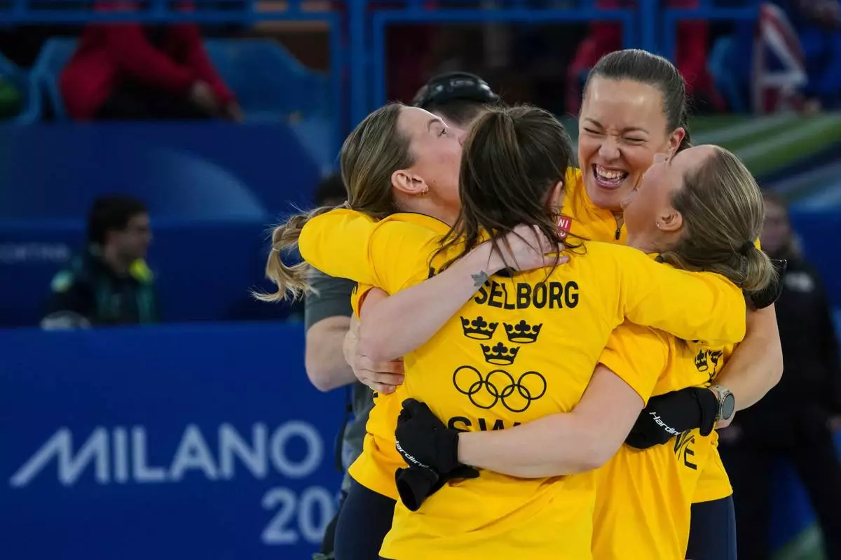 Sweden's Anna Hasselborg, Sara McManus, Sofia Scharback, Agnes Knochenhauer celebrate after winning a women's curling semifinal match against Canada, at the 2026 Winter Olympics, in Cortina d'Ampezzo, Italy, Friday, Feb. 20, 2026. (AP Photo/Misper Apawu)