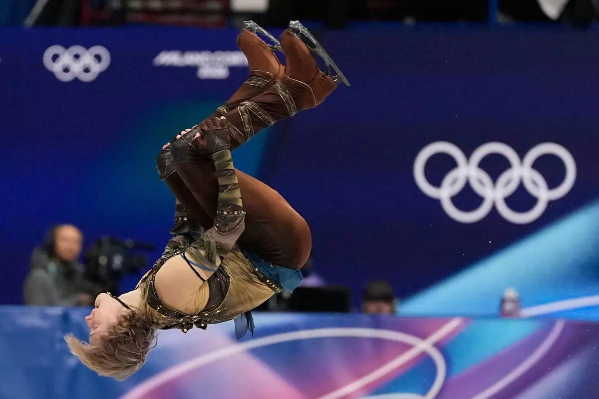 Ilia Malinin of the United States does a back flip while competing during the men's figure skating short program at the 2026 Winter Olympics, in Milan, Italy, Tuesday, Feb. 10, 2026. (AP Photo/Ashley Landis)