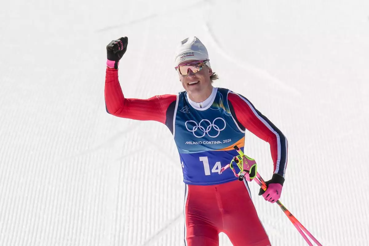 Johannes Hoesflot Klaebo, of Norway, approaches the finish line to win the gold medal in the cross country skiing men's 4 x 7.5km relay at the 2026 Winter Olympics, in Tesero, Italy, Sunday, Feb. 15, 2026. (AP Photo/Evgeniy Maloletka)