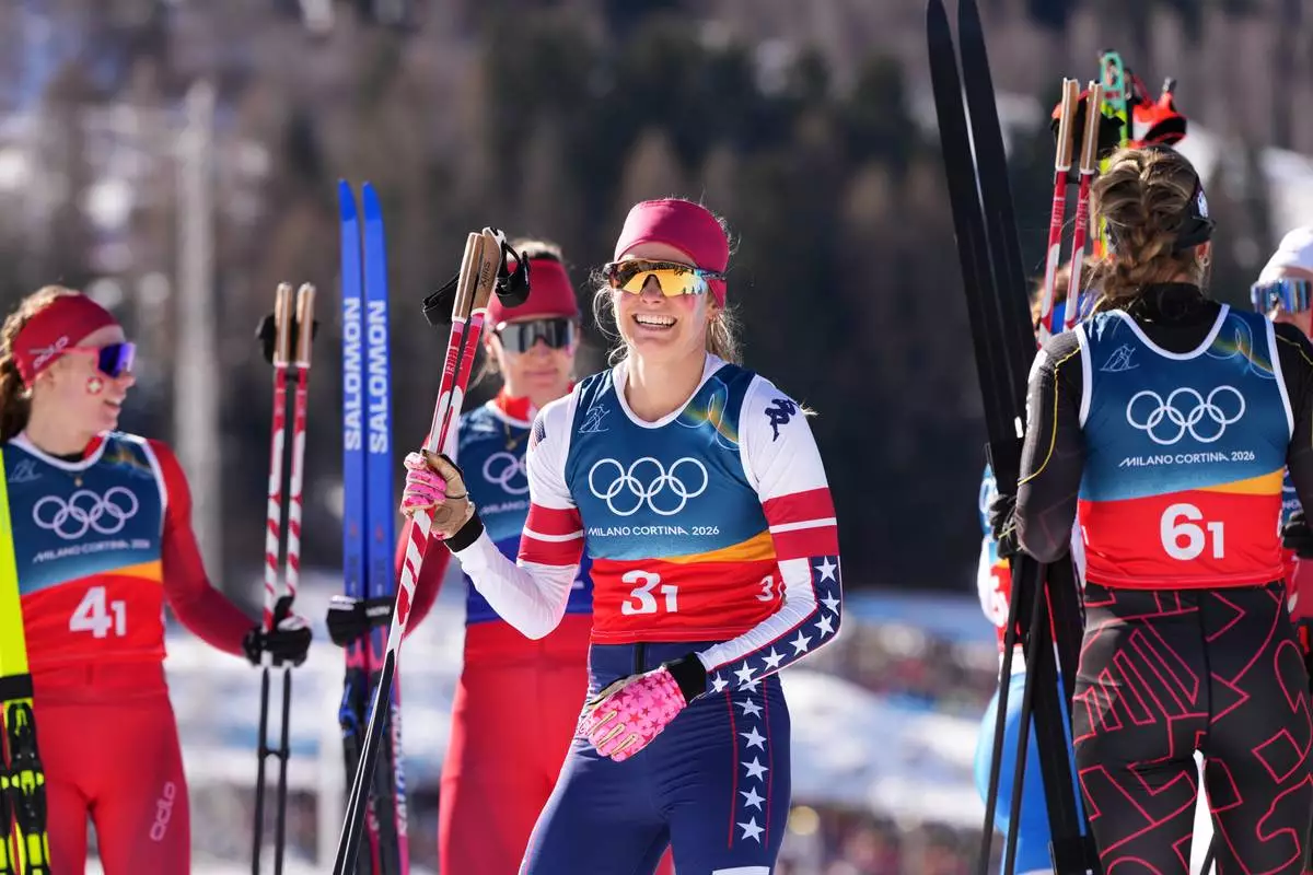 Jessie Diggins, of the United States, smiles after finishing the cross-country skiing women's team sprint free at the 2026 Winter Olympics, in Tesero, Italy, Wednesday, Feb. 18, 2026. (AP Photo/Kirsty Wigglesworth)