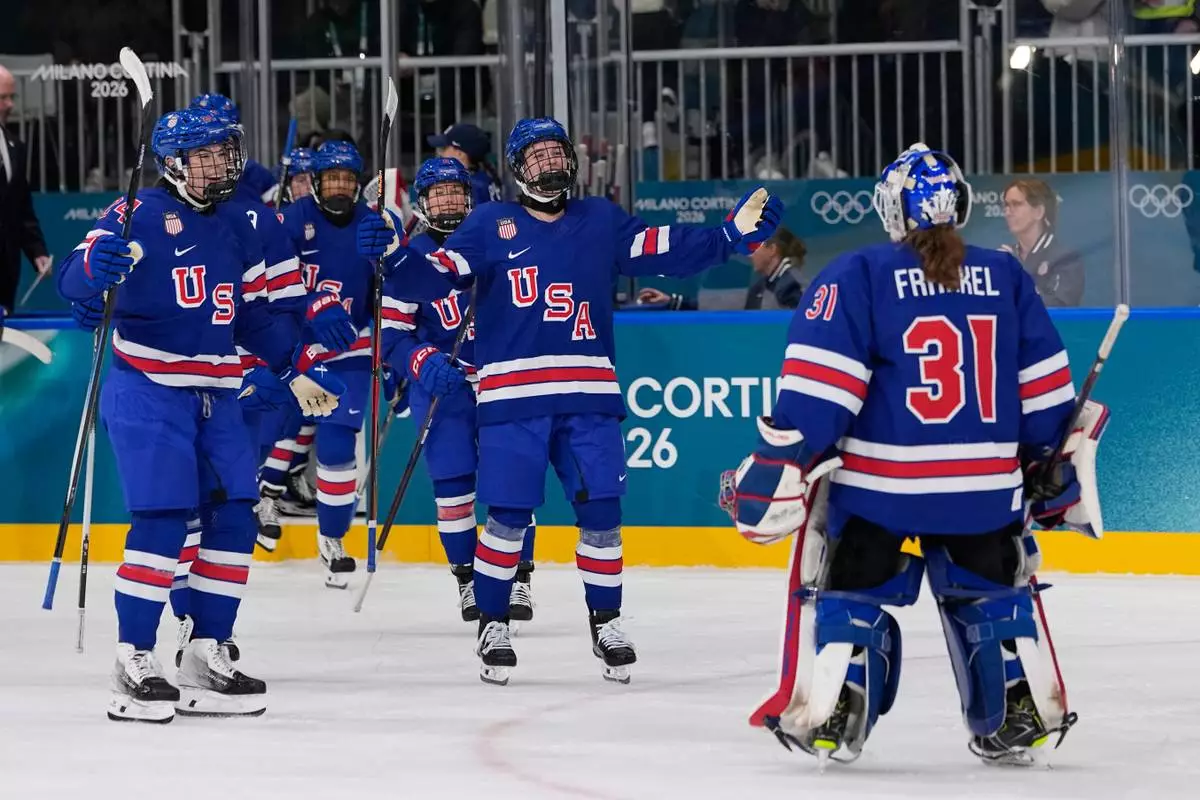 United States' Aerin Frankel, right, celebrates with teammates after a preliminary round match of women's ice hockey between the United States and Finland at the 2026 Winter Olympics, in Milan, Italy, Saturday, Feb. 7, 2026. (AP Photo/Petr David Josek)
