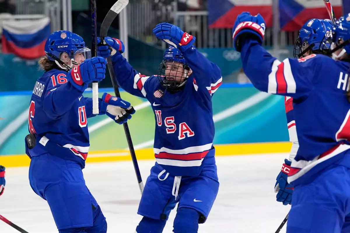 United States' Hayley Scamurra, left, celebrates after scoring her side's fifth goal during a preliminary round match of women's ice hockey between United States and Czechia at the 2026 Winter Olympics, in Milan, Italy, Thursday, Feb. 5, 2026. (AP Photo/Petr David Josek)