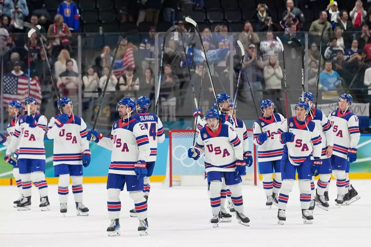 United States players celebrate at the end of a men's ice hockey semifinal game between the United States and Slovakia at the 2026 Winter Olympics, in Milan, Italy, Friday, Feb. 20, 2026. (AP Photo/Hassan Ammar)