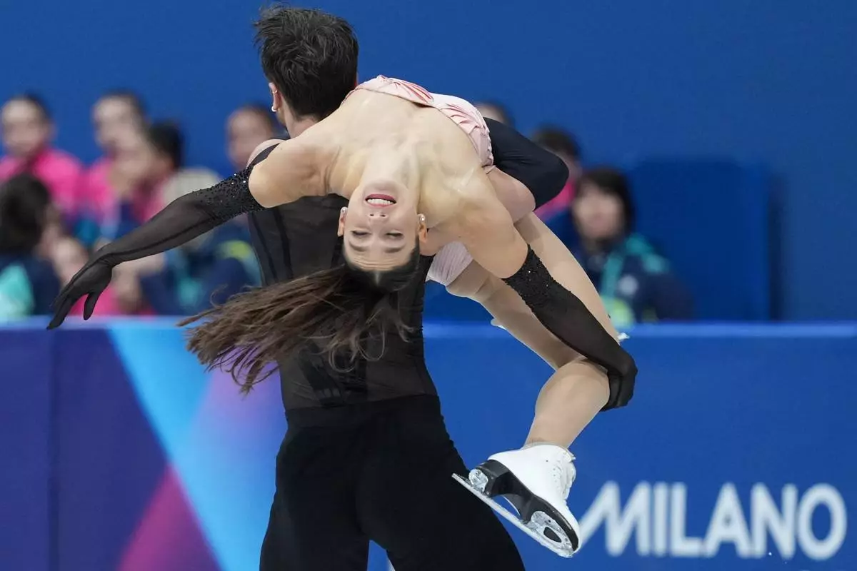 Laurence Fournier Beaudry and Guillaume Cizeron of France compete during the figure skating ice dance team event at the 2026 Winter Olympics, in Milan, Italy, Friday, Feb. 6, 2026. (AP Photo/Stephanie Scarbrough)