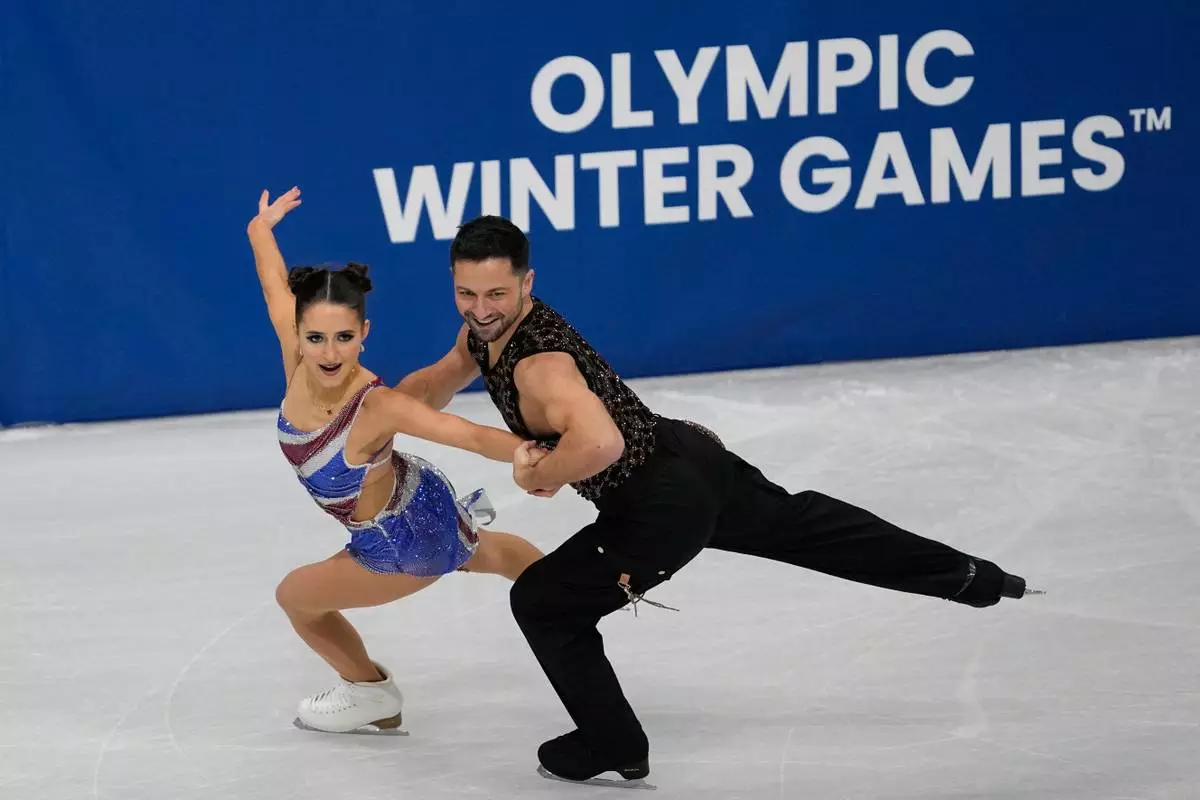 Lilah Fear and Lewis Gibson of Britain compete during the figure skating ice dance team event at the 2026 Winter Olympics, in Milan, Italy, Friday, Feb. 6, 2026. (AP Photo/Ashley Landis)