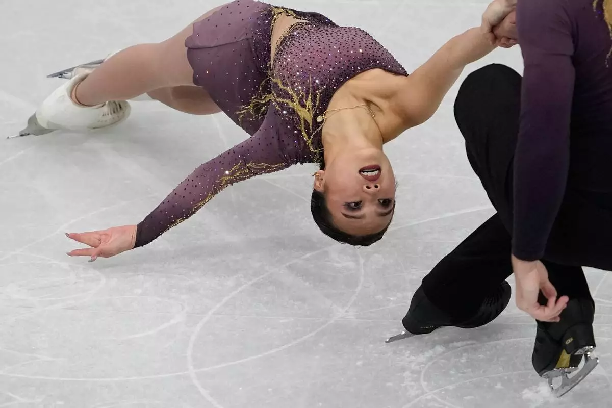 Ellie Kam and Danny O'Shea of the United States compete during the figure skating pairs team event at the 2026 Winter Olympics, in Milan, Italy, Friday, Feb. 6, 2026. (AP Photo/Ashley Landis)