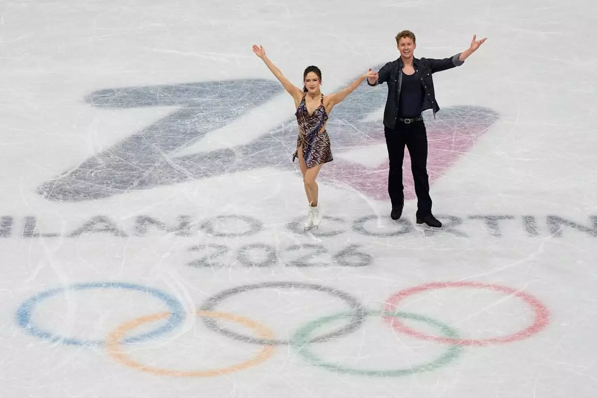 Madison Chock and Evan Bates of the United States compete during the figure skating ice dance team event at the 2026 Winter Olympics, in Milan, Italy, Friday, Feb. 6, 2026. (AP Photo/Ashley Landis)