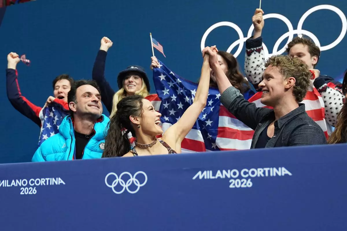 Madison Chock and Evan Bates of the United States react to their scores after competing during the figure skating ice dance team event at the 2026 Winter Olympics, in Milan, Italy, Friday, Feb. 6, 2026. (AP Photo/Stephanie Scarbrough)