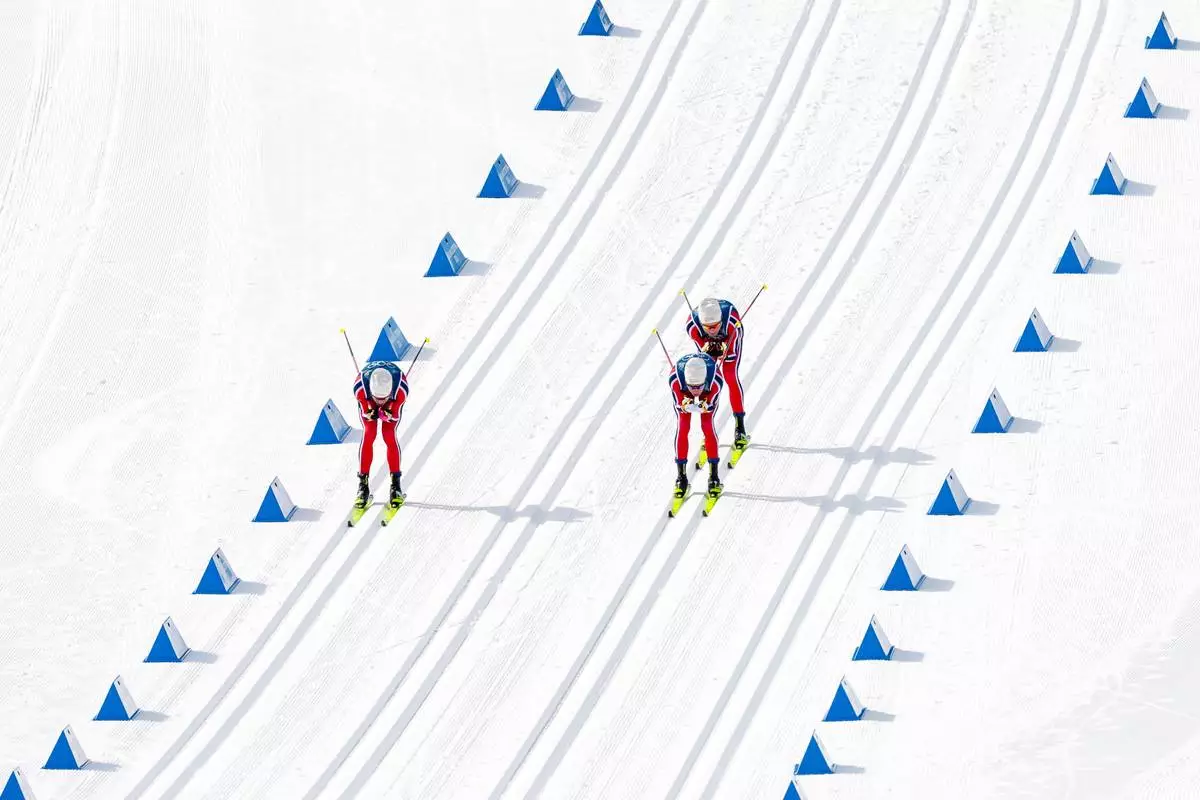 Johannes Hoesflot Klaebo, from left, Martin Loewstroem Nyenget and Emil Iversen, all three of Norway, compete in the cross country skiing men's 50km mass start Classic at the 2026 Winter Olympics, in Tesero, Italy, Saturday, Feb. 21, 2026. (AP Photo/Kirsty Wigglesworth)