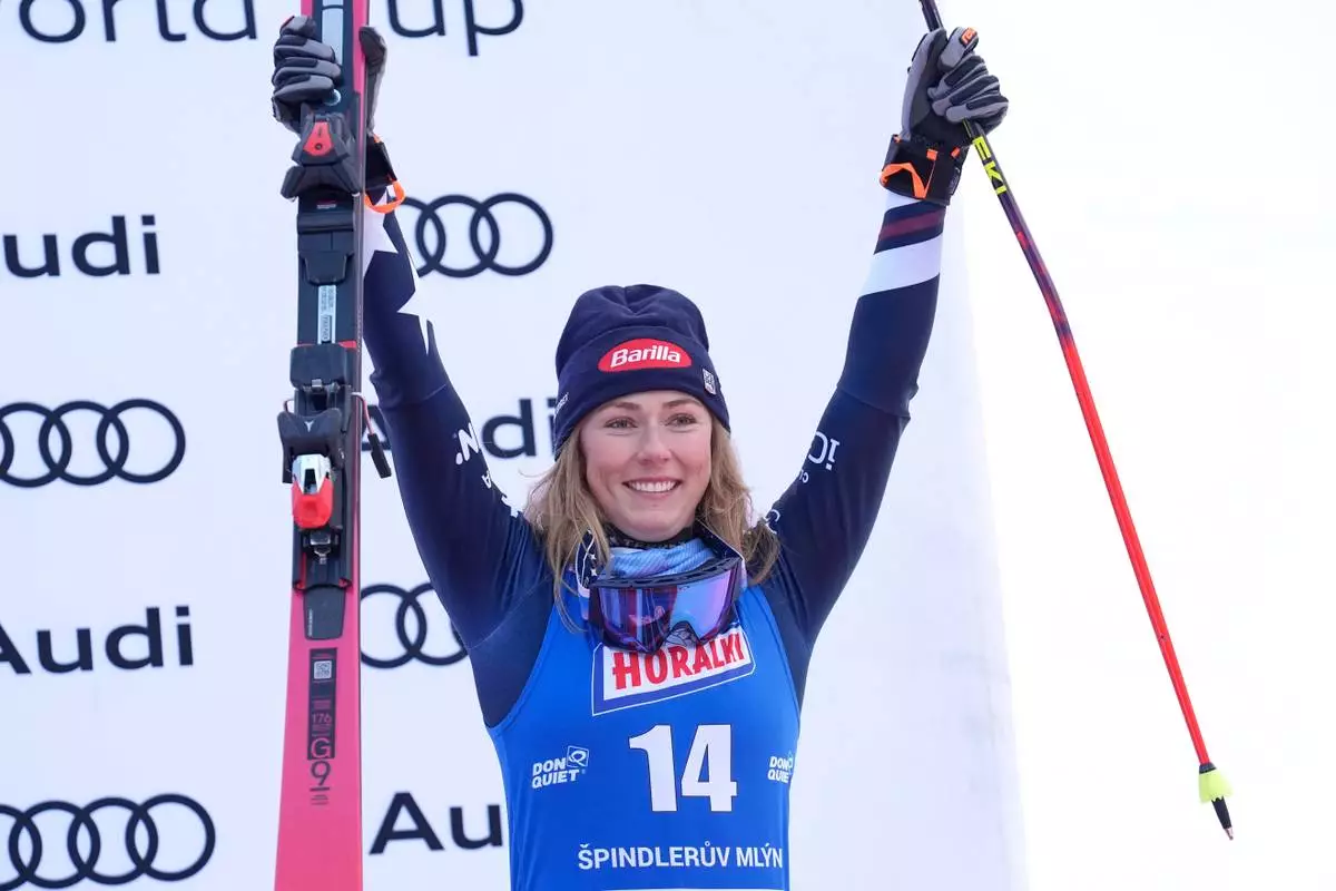 United States' Mikaela Shiffrin celebrates on podium after finishing third in a women's alpine ski, World Cup giant slalom, in Spindleruv Mlyn, Czech Republic, Saturday, Jan. 24, 2026. (AP Photo/Giovanni Auletta)