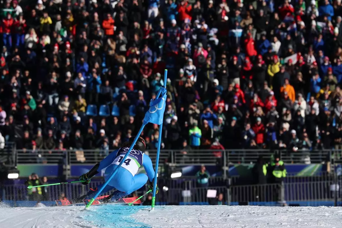 Italy's Federica Brignone speeds down the course on her way to win an alpine ski, women's giant slalom race, at the 2026 Winter Olympics, in Cortina d'Ampezzo, Italy, Feb. 15, 2026. (AP Photo/Marco Trovati, File)