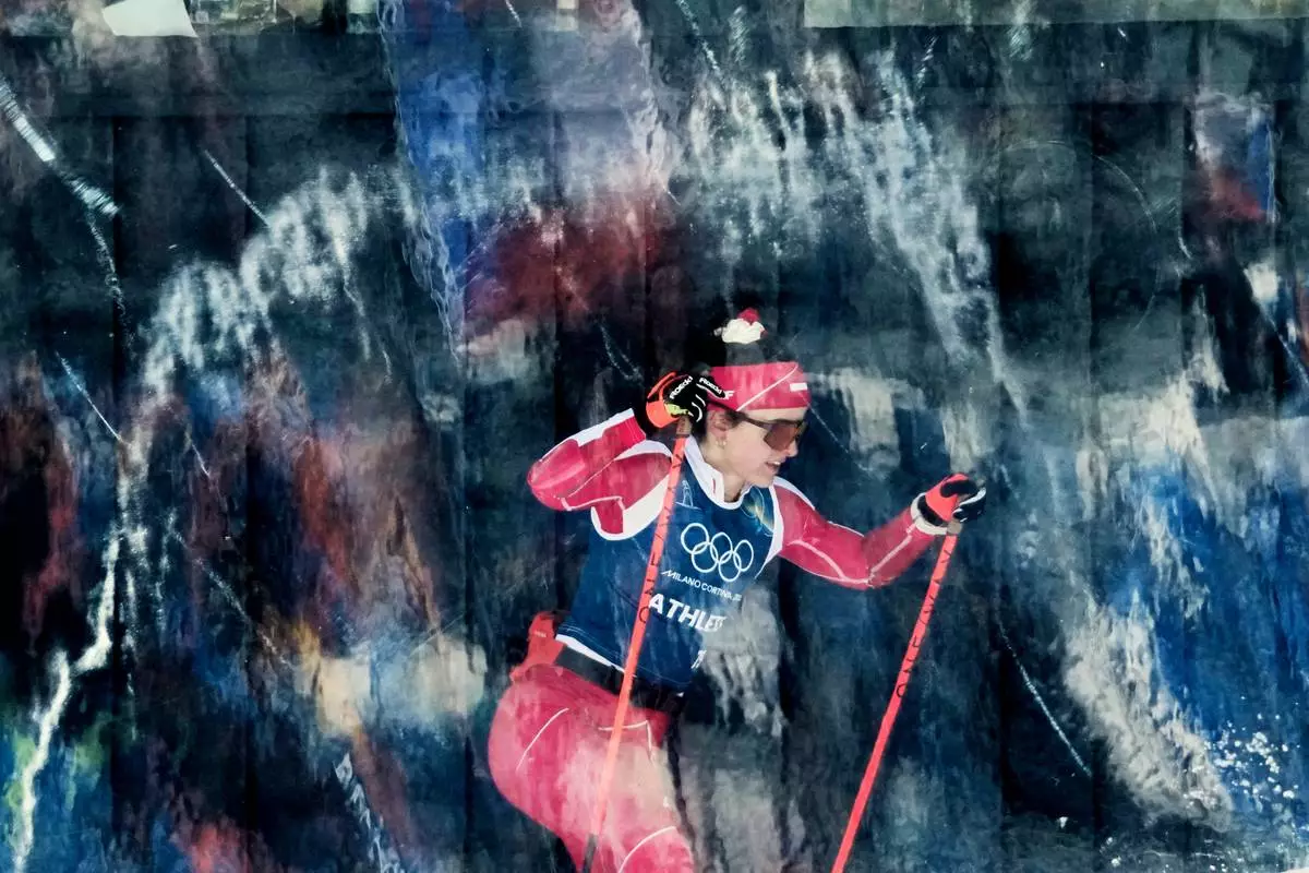 Poland's Anna Maka passes behind a glass wall while training on the biathlon course at the 2026 Winter Olympics, in Anterselva, Italy, Feb. 20, 2026. (AP Photo/David J. Phillip, File)
