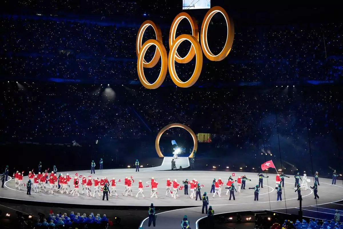 Athletes from Switzerland walk during the Olympic opening ceremony at the 2026 Winter Olympics, in Milan, Italy, Feb. 6, 2026. (AP Photo/Lee Jin-man, File)
