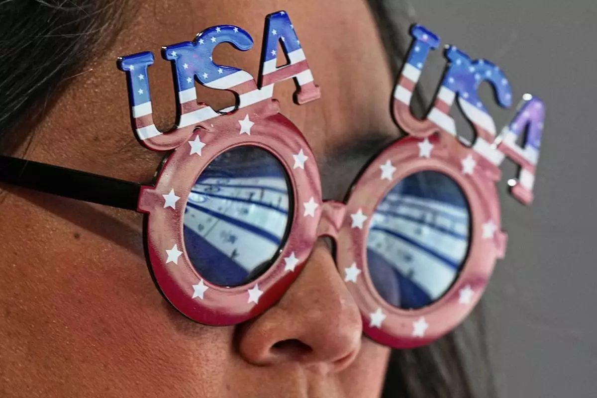 A United States supporter watches a women's curling semifinal match between Switzerland and the United States, at the 2026 Winter Olympics, in Cortina d'Ampezzo, Italy, Friday, Feb. 20, 2026. (AP Photo/Fatima Shbair)