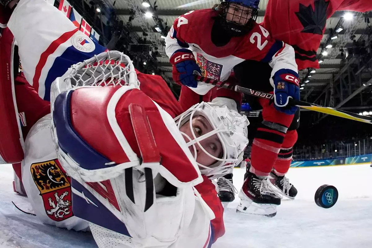 Czechia's Michaela Hesova looks on as Canada's Julia Gosling scores her side's fourth goal during a preliminary round match of women's ice hockey between Canada and Czechia at the 2026 Winter Olympics, in Milan, Italy, Feb. 9, 2026. (AP Photo/Darko Bandic, Pool, File)