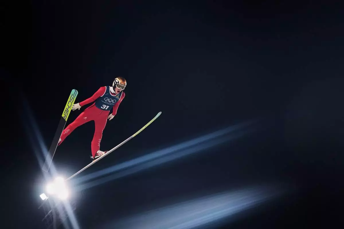 Gregor Deschwanden, of Switzerland, soars through the air during a ski jumping, men's normal hill, training session, at the 2026 Winter Olympics, in Predazzo, Italy, Feb. 8, 2026. (AP Photo/Kirsty Wigglesworth, File)