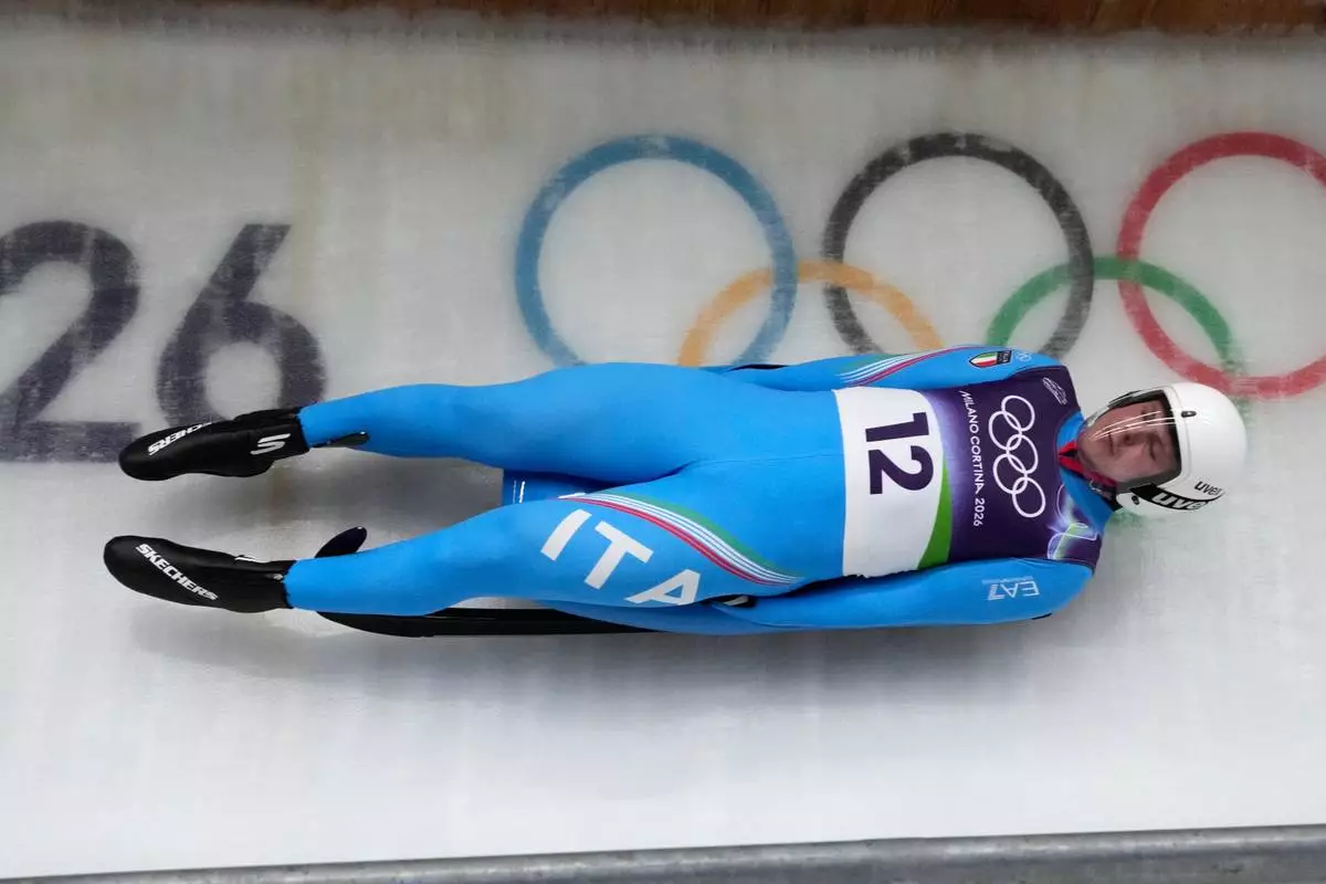 Italy's Dominik Fischnaller slides down the track during a men's single luge run at the 2026 Winter Olympics, in Cortina d'Ampezzo, Italy, Sunday, Feb. 8, 2026. (AP Photo/Aijaz Rahi)