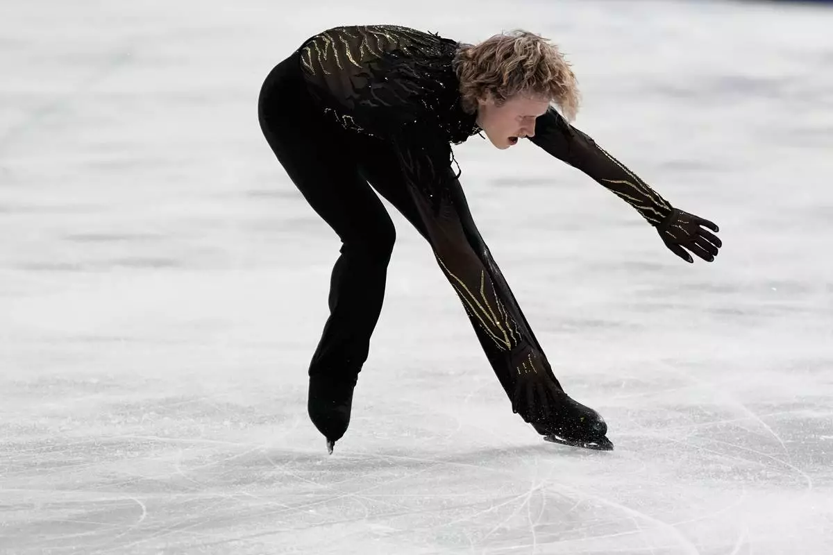 Ilia Malinin of the United States falls during the men's free skate program in figure skating at the 2026 Winter Olympics, in Milan, Italy, Friday, Feb. 13, 2026. (AP Photo/Natacha Pisarenko)