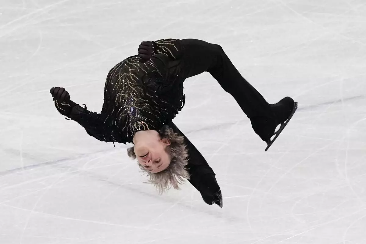 Ilia Malinin of the United States does a back flip while competing during the men's free skate program in figure skating at the 2026 Winter Olympics, in Milan, Italy, Friday, Feb. 13, 2026. (AP Photo/Stephanie Scarbrough)