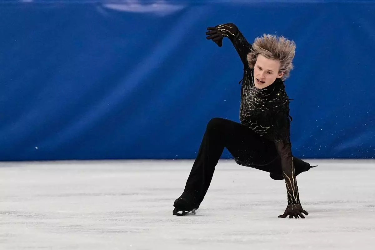 Ilia Malinin of the United States falls during the men's free skate program in figure skating at the 2026 Winter Olympics, in Milan, Italy, Friday, Feb. 13, 2026. (AP Photo/Ashley Landis)