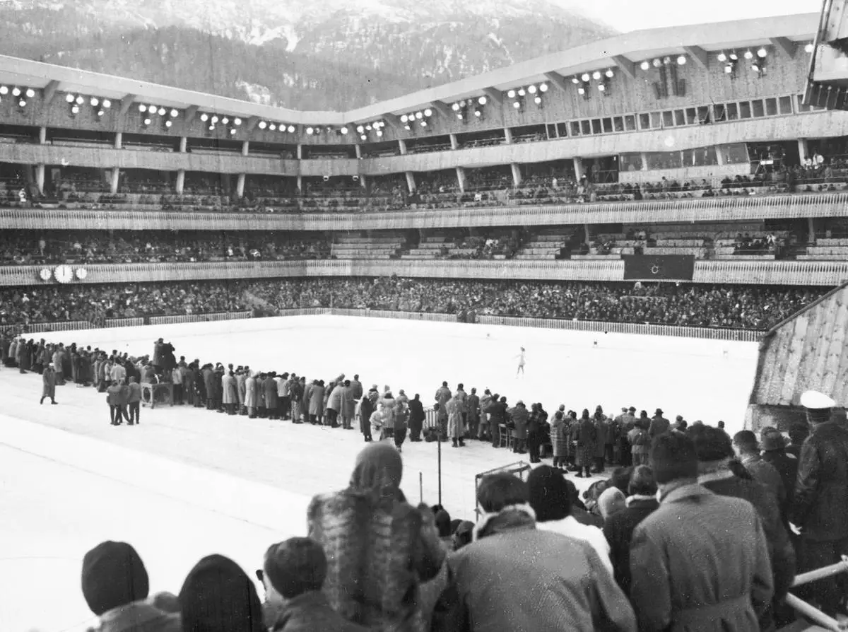 FILE - A view of the stadium as United States' Carol Heiss performs in the women's figure skating event, in the seventh Winter Olympic Games, in Cortina d'Ampezzo, Italy, Feb. 2, 1956. (AP Photo/Hans von Nolde, File)
