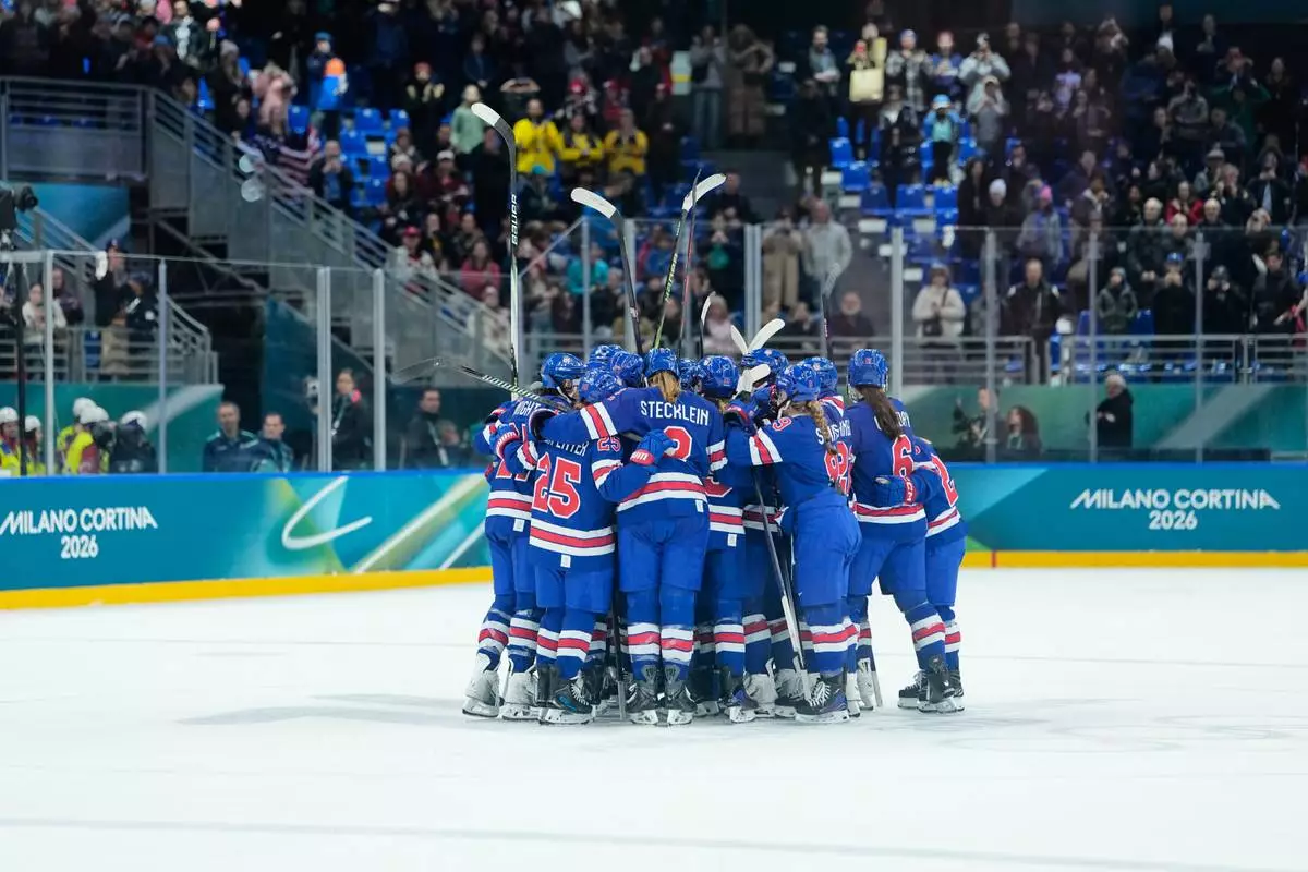 U.S. players celebrate after a semifinal match of women's ice hockey between the United States and Sweden at the 2026 Winter Olympics, in Milan, Italy, Monday, Feb. 16, 2026. (AP Photo/Petr David Josek)