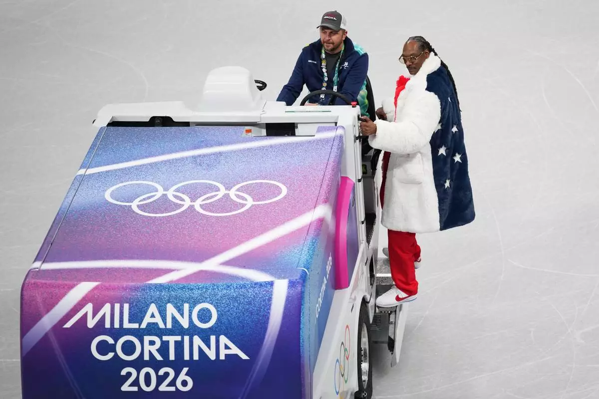 American artist Snoop Dogg stands on an ice resurfacer at the figure skating venue rink ahead of the 2026 Winter Olympics in Milan, Italy, on Tuesday, Feb. 3, 2026. (AP Photo/Christophe Ena)