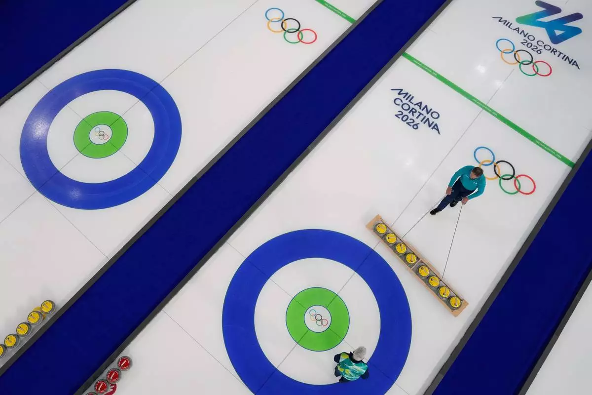 Preparations for the first curling competition are made at the 2026 Winter Olympics in Cortina d'Ampezzo, Italy, Wednesday, Feb. 4, 2026. (AP Photo/David J. Phillip)
