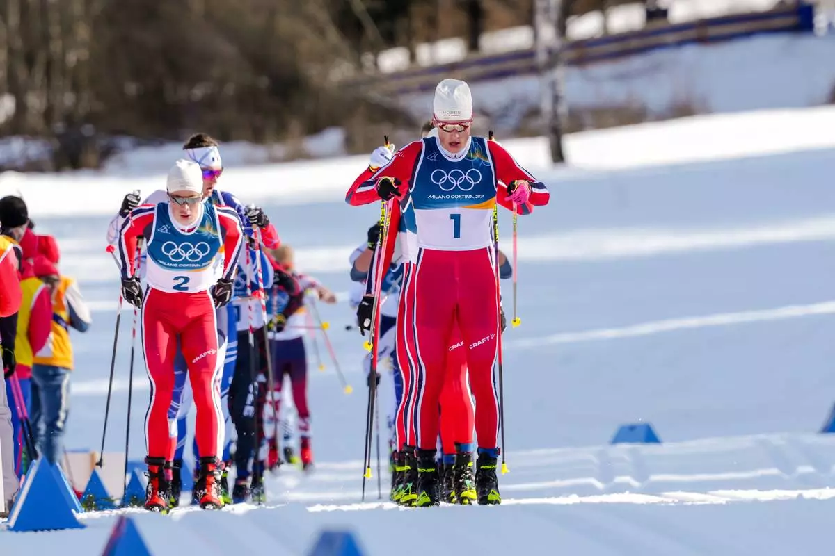 Johannes Hoesflot Klaebo, of Norway, and Harald Oestberg Amundsen, also of Norway, right, compete in the cross country skiing men's 10km + 10km skiathlon at the 2026 Winter Olympics, in Tesero, Italy, Sunday, Feb. 8, 2026. (AP Photo/Evgeniy Maloletka)