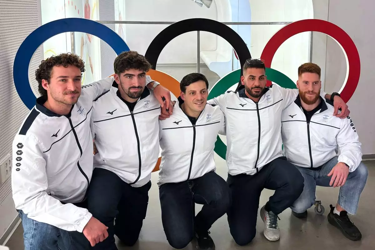Members of Israel's bobsledding team, from left, Uri Zisman, Omer Katz, AJ Edelman, Ward Farwaseh, Itamar Shprinz, pose at the Israel Olympic Committee headquarters, Wednesday, Jan. 28, 2026, in Tel Aviv, Israel, before their departure for the 2026 Winter Olympics. (AP Photo/Julia Frankel)