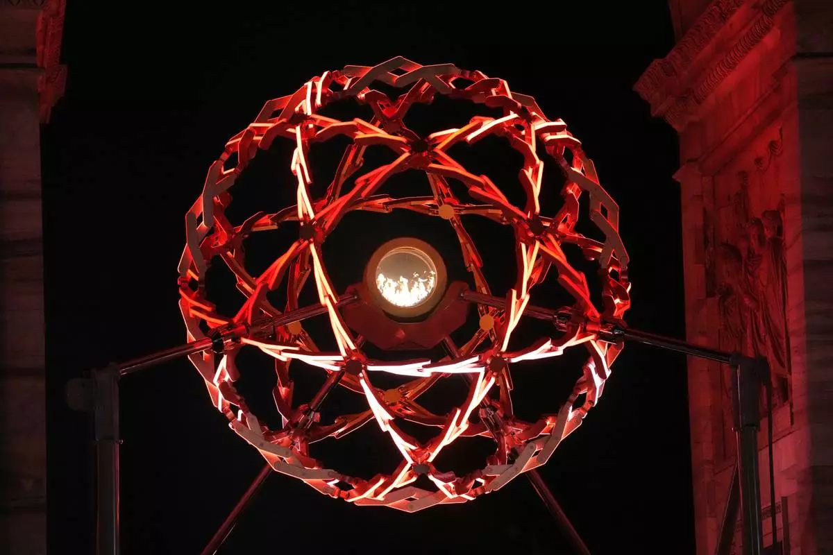 A view of the lit cauldron at the Arco della Pace during the Olympic opening ceremony at the 2026 Winter Olympics, in Milan, Italy, Friday, Feb. 6, 2026. (AP Photo/Christophe Ena)