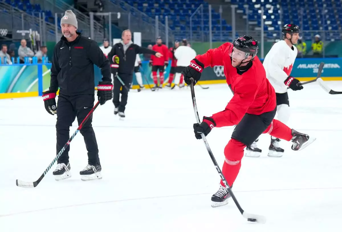 Canada forward Connor McDavid, front right, takes part in a men's ice hockey practice during the 2026 Winter Olympics in Milan, Italy, Sunday, Feb. 8, 2026. (Nathan Denette/The Canadian Press via AP)