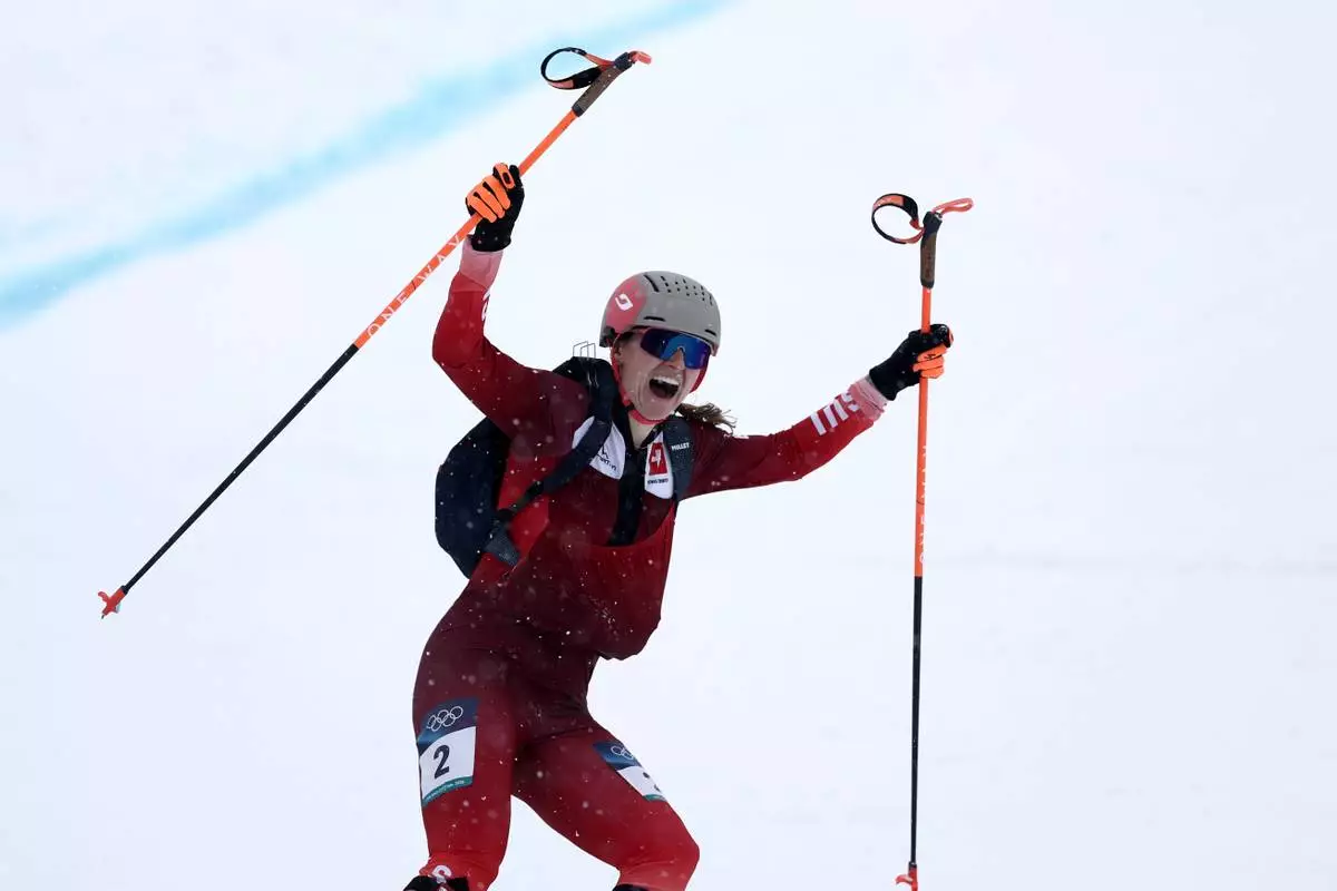 Switzerland's Marianne Fatton celebrates winning a ski mountaineering women's final at the 2026 Winter Olympics, in Bormio, Italy, Thursday, Feb. 19, 2026. (AP Photo/Gabriele Facciotti)